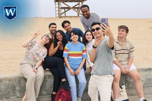 Westcliff University students take a photo together at the beach