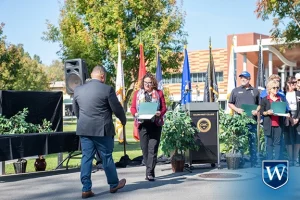 Westcliff University's Cristian Cabrera accepts Golden West College Veteran's Day certificate of appreciation