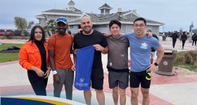 Westcliff University Cross Country Head Coach Abdurrahman Muhammad on track field, marking the program's 2025 return; MBA alumnus and student mentor leading athletic and academic excellence.