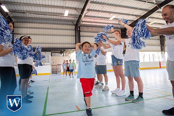 Volunteers cheer for young bike rider